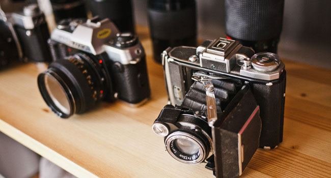 Vintage cameras on a wooden shelf