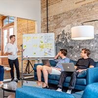 A small team planning on a whiteboard
